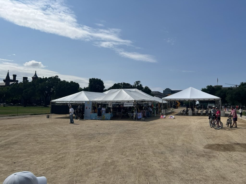 Event pavilion on the National Mall with the Smithsonian Castle in the distance