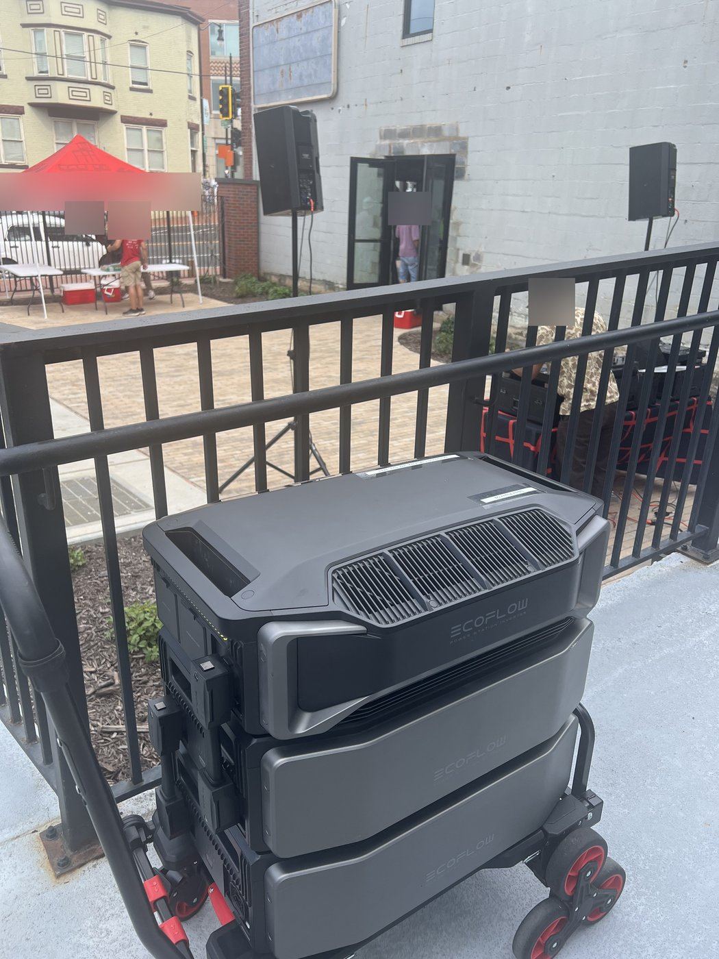 Battery power rig beside speakers at a street plaza event